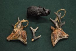 Two miniature carved wood deers heads and a model of an elephant.