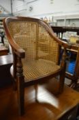A 19th century mahogany miniature bergere armchair.