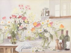 S J ANDREWS (20TH CENTURY) Kitchen still life of colourful flowers and wine bottles, watercolour,