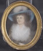 ATTRIBUTED TO SIR THOMAS LAWRENCE Portrait of a lady wearing a blue hat, pastel, in oval frame
