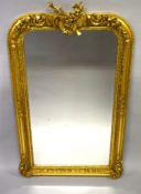 A LOUIS XVI DESIGN GILTWOOD MIRROR with musical trophies. 5ft high x 2ft 9ins wide.