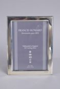 A STERLING SILVER PHOTOGRAPH FRAME, 7ins x 5ins.