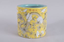 A CHINESE PORCELAIN YELLOW GROUND BRUSH POT painted with dragons. 7.5ins high.