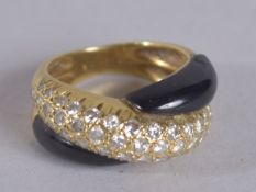 AN 18CT DIAMOND AND BLACK ONYX RING.