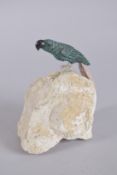 A CARVED STONE BIRD on a rock. 6ins high.
