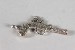A SILVER NOVELTY PISTOL WHISTLE.