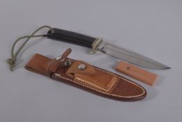 A RANDALL ORLANDO HUNTING KNIFE 10.5Ins long in a leather case.