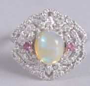 AN ORNATE DRESS RING IN SILVER SET WITH A CABOCHON OPAL, PINK TOURMALINES AND DIAMONDS. Opal 2.