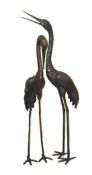A VERY LARGE PAIR OF BRONZE HERONS. 5ft 8ins high and 5ft high.