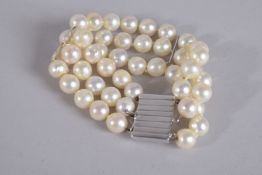 A GOLD TRIPLE ROW PEARL BRACELET with 18ct white gold clasp