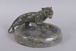 A PATINATED BRONZE FIGURE OF A TIGER, mounted on a Brazilian onyx dish, Circa. 1940. 17cms high x
