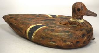 A MEDIUM CARVED WOOD AND PAINTED DECOY DUCK. 13ins high.