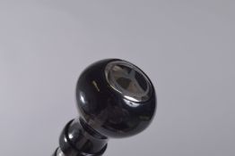 A WALKING STICK WITH MERCEDES HANDLE.