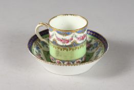 A GOOD SEVRES CUP AND SAUCER painted with roses. Sevres mark in blue.