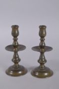 A PAIR OF DUTCH BRASS CANDLESTICKS ON CIRCULAR BASES. 8.5ins high.