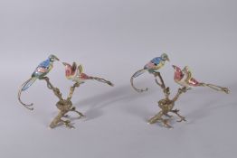 A PAIR OF PORCELAIN AND GILT METAL BIRD CANDLESTICKS with nest and two birds. 9.5ins high.