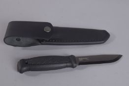 A MORAKNIV SWEDISH CARBON KNIFE 9in long in a leather case and box.