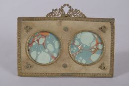 AN EMPIRE ORMOLU DOUBLE PHOTOGRAPH FRAME. 6.5ins wide x 4.75ins high.