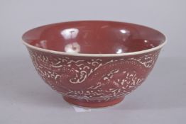 A CHINESE COPPER RED DRAGON AND PHOENIX BOWL. 21cms diameter.