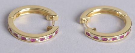 A PAIR OF 18CT RUBY AND DIAMOND HOOP EARRINGS.