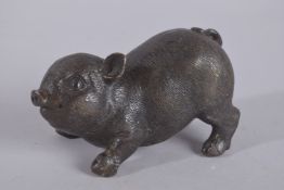 A SMALL BRONZE BABY PIG. 4.5ins.