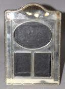 A TRIPLE SILVER PLATED PHOTOGRAPH FRAME with serpentine top. 7ins x 4.75ins.