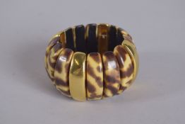 A KENNETH LANE VINTAGE LEOPARD PRINT FLEXIBLE BRACELET, signed, 3ins diameter.
