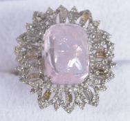 A LARGE SILVER DRESS RING, WITH A CENTRAL CUSHION CABOCHON MORGANITE, with surrounding baguette