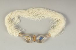 A SUPERB NECKLACE by POIRAY, AKOYA SEED PEARLS with diamonds and sapphires.