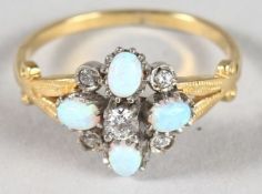 A SILVER AND GOLD FINISH OPAL CLUSTER RING.
