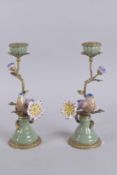 A PAIR OF PORCELAIN AND METAL CANDLESTICKS with a bird and flower. 12ins high.