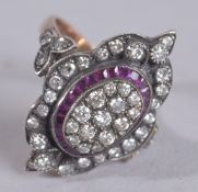 AN 8CT ROSE GOLD NAVETTE SHAPED DRESS RING WITH CALIBRE CUT RUBIES AND ROUND CUT, BRILLIANT CUT