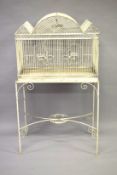 A WHITE PAINTED BIRD CAGE ON STAND.