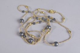 A STERLING SILVER GILT OXIDISED BEAD NECKLACE 48ins long.