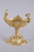 A GOOD GILT BRONZE OVAL PEDESTAL SALT with cupid handle. 8ins high.