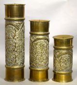 A GARNITURE OF THREE BRASS CANDLESTICKS. 14ins, 11ins and 8ins high.