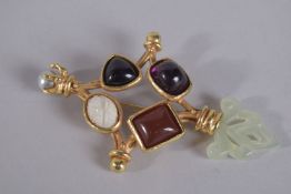 A LAGRO USA GILT HARDSTONE BROOCH.