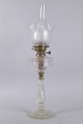 A GOOD VICTORIAN CUT GLASS OIL LAMP, Youngs Patent, with etched glass shade and plain funnel.