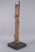 AN EARLY DOGON TELLEM FIGURE, moulded on a later plinth base. Height of Figure: 37ins.