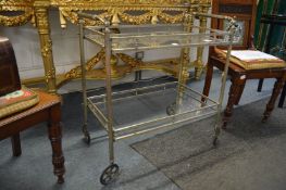A SYTLISH MID-CENTURY CHROME PLATED BRASS TWO-TIER TROLLEY. 2ft 5ins long x 2ft 6ins high.