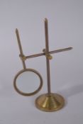 A MAGNIFYING GLASS on a stand.