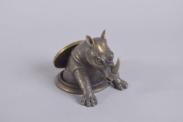 A BRONZE RHINO DESK WEIGHT, on a circular base. 3.5ins diameter.