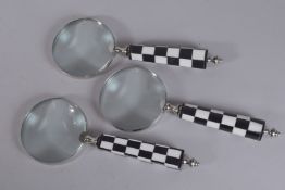 THREE MAGNIFYING GLASSES with chequered handles and another with silver handle (4).