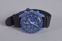 AN OMEGA SWATCH WRIST WATCH with black strap. Speedmaster in a velvet case.