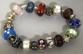 A PANDORA BRACELET AND 18 CHARMS