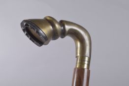 A WALKING STICK WITH HORSES HOOF HANDLE.