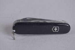 A VICTORINOX SWISS FOLDING FOUR PIECE KNIFE.