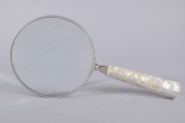 A LARGE MAGNIFYING GLASS with mother-of-pearl handle. 6ins diameter.
