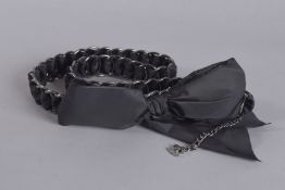 A CHANEL BLACK BELT with bow. 35ins long.