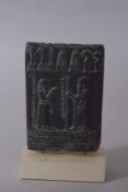 A MUSEUM COPY OF A PERSIAN TABLET ON STAND. 8.5ins high.